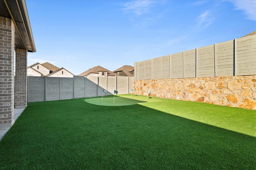 1332 Thompson Road Argyle, TX 76226 - Photo 30 of 36 Fenced backyard with a putting area