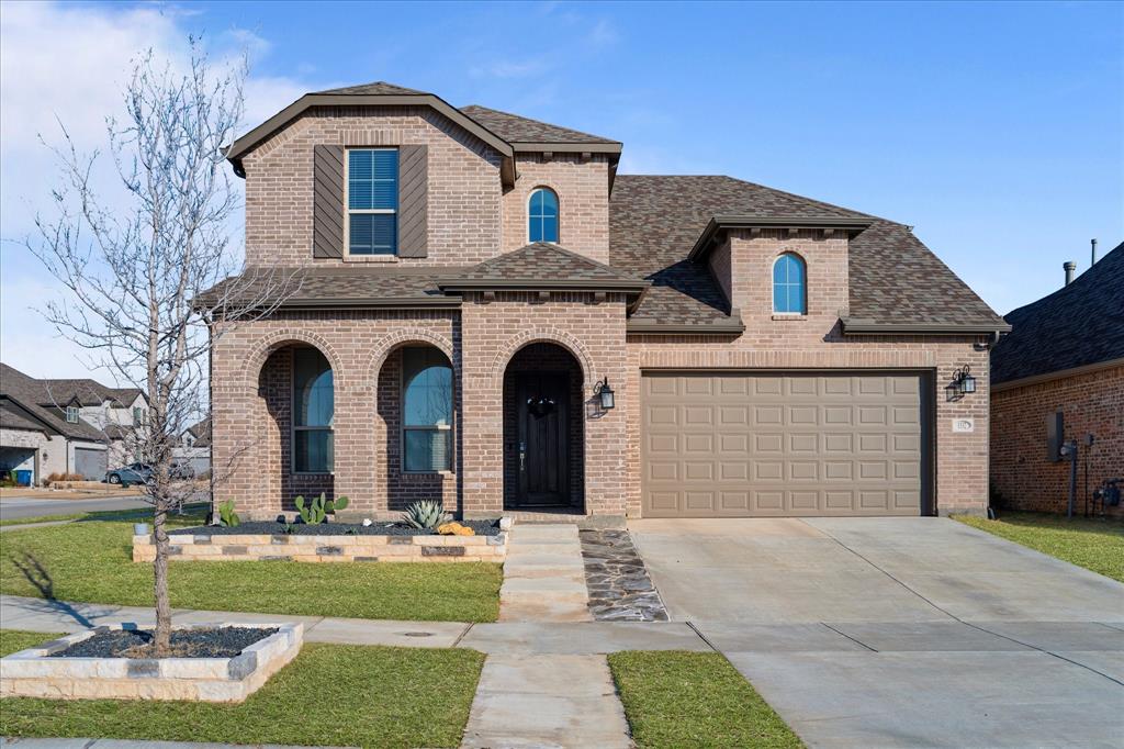 1332 Thompson Road Argyle, TX 76226 - Photo 33 of 36 French country home featuring roof with shingles, a porch, brick siding, driveway, and a front lawn
