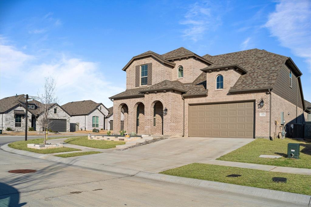 1332 Thompson Road Argyle, TX 76226 - Photo 34 of 36 French provincial home featuring brick siding, concrete driveway, and a residential view