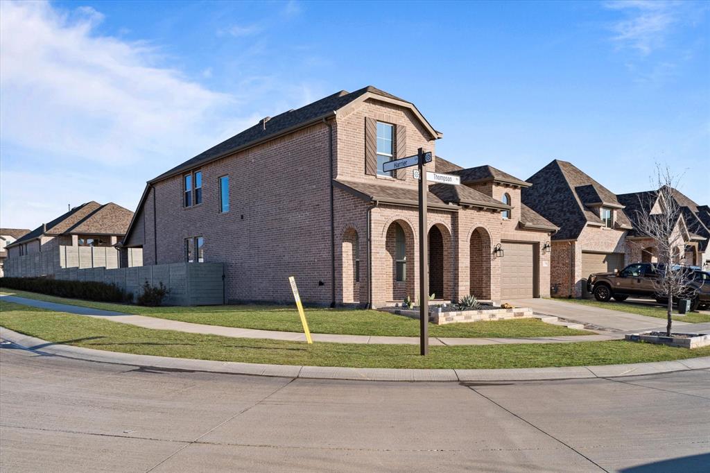 1332 Thompson Road Argyle, TX 76226 - Photo 35 of 36 View of front facade with brick siding, a garage, a residential view, and driveway