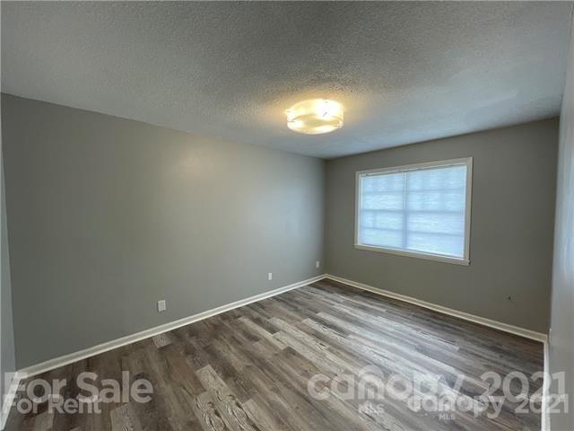 5805 Hunting Ridge Lane, Unit A Charlotte, NC 28212 - Photo 4 of 4 a view of an empty room with a window