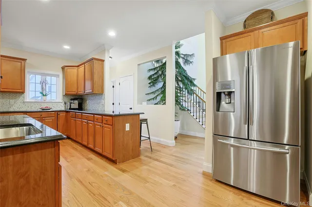 a kitchen with stainless steel appliances granite countertop a refrigerator a sink a stove a microwave and island