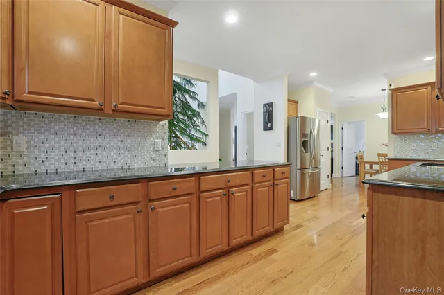 a view of a kitchen with stainless steel appliances granite countertop a refrigerator and a sink
