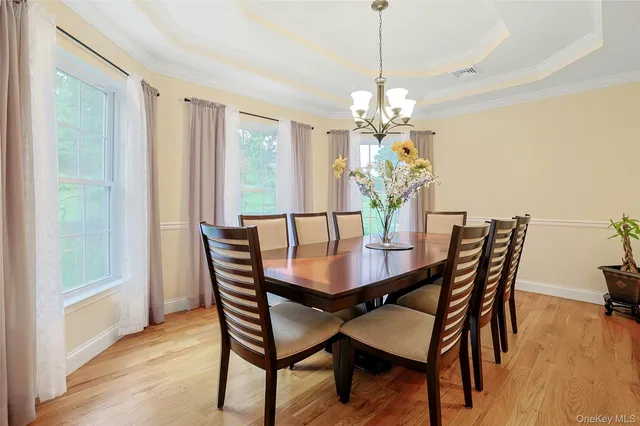 a dining room with furniture potted plants and wooden floor