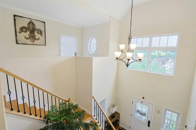 a spacious bedroom with a bed and a flat screen tv