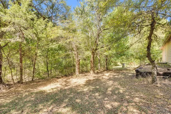 a backyard of a house with large trees