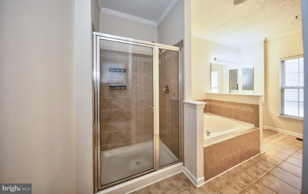 a bathroom with a tub and shower