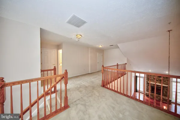 a view of an empty room with stairs