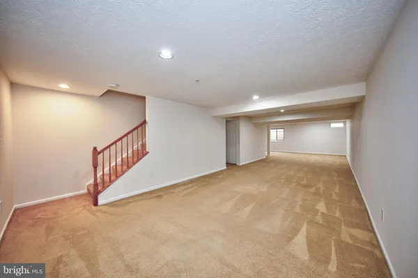 a view of an empty room with stairs