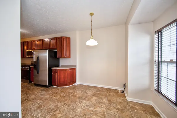 a kitchen with refrigerator and window