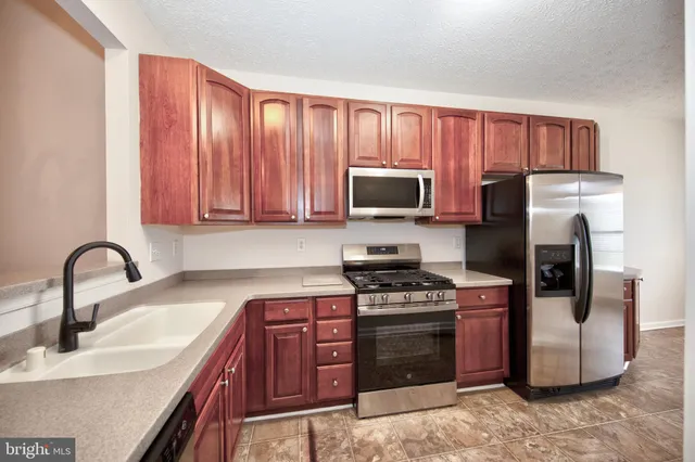 a view of an empty room with a ceiling fan and window