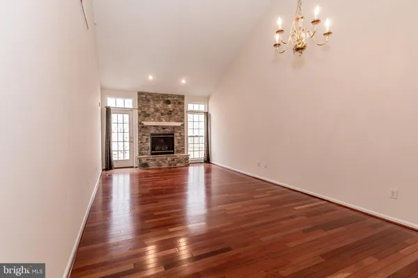 a view of a room with wooden floor and fireplace
