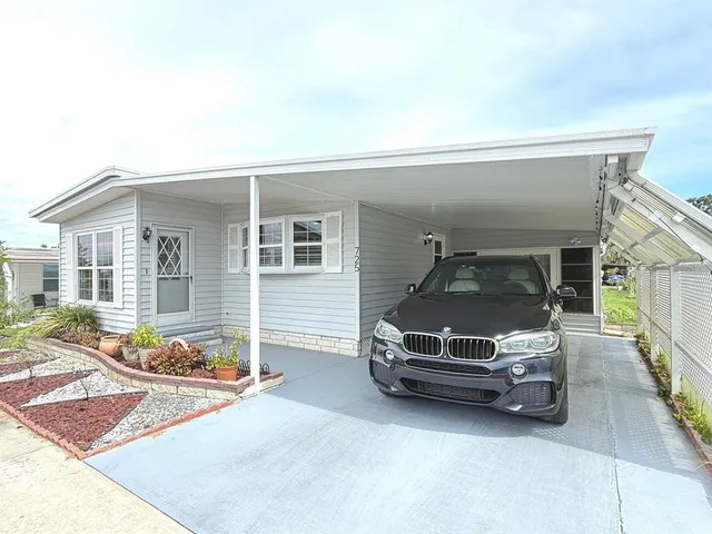 a front view of a house with garden and plants