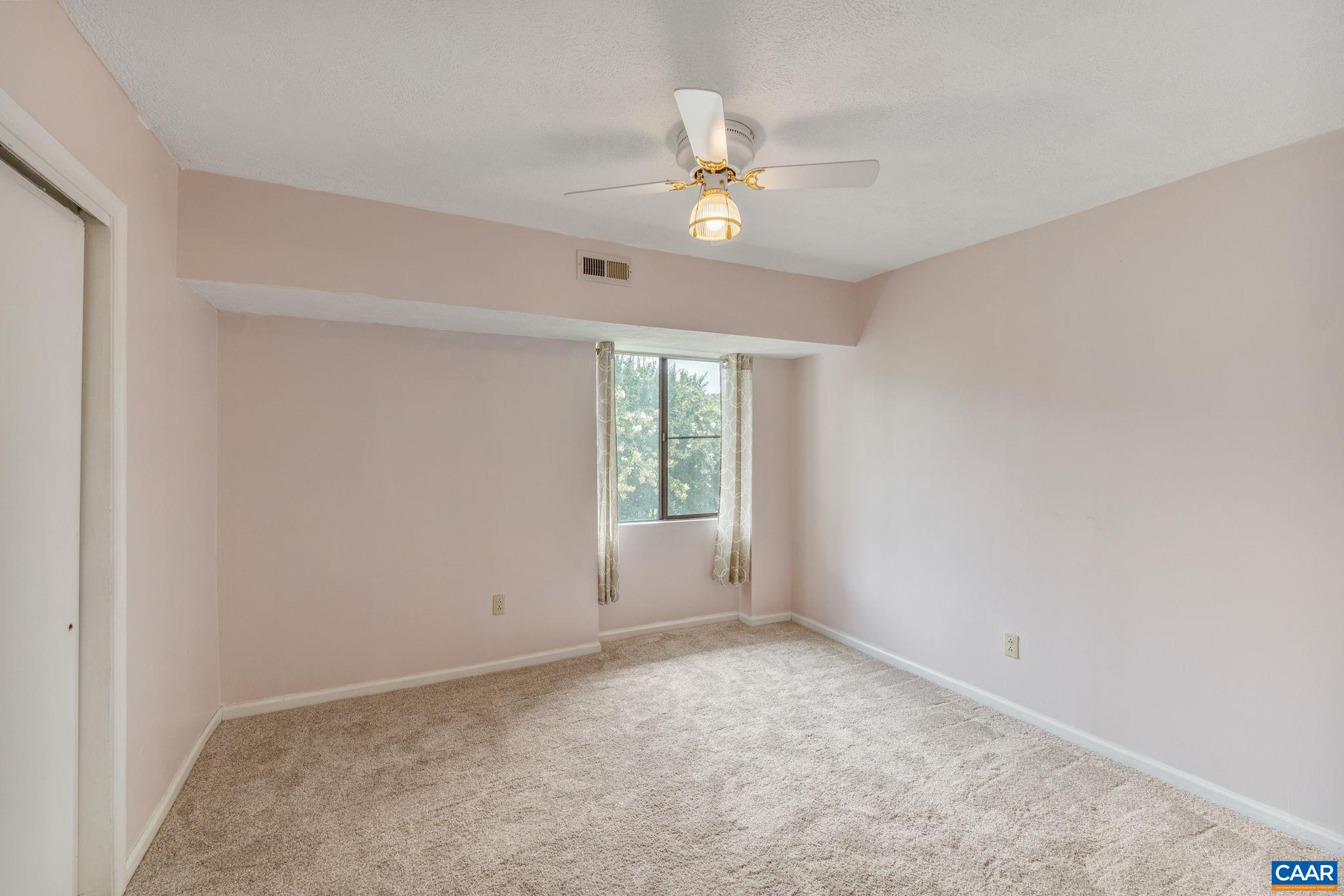 33 Spring Court Charlottesville, VA 22901 - Photo 23 of 26 an empty room with a chandelier fan and windows