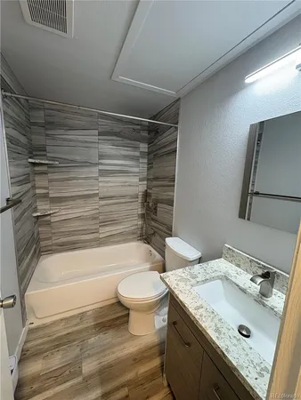 a bathroom with a sink toilet and shower