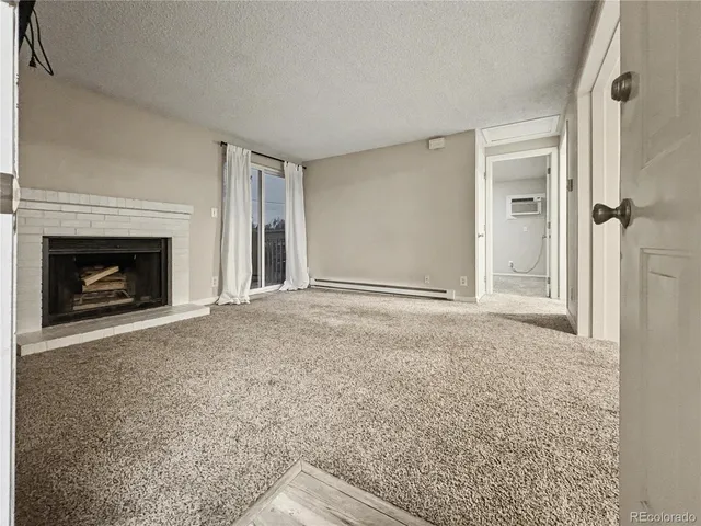 a view of empty room with a fireplace