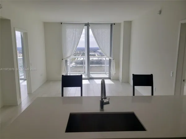 a view of kitchen with furniture and refrigerator