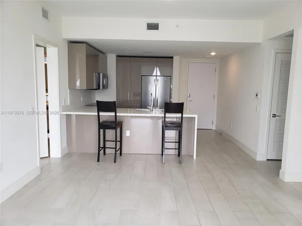 a view of a hallway with a room and a bathroom