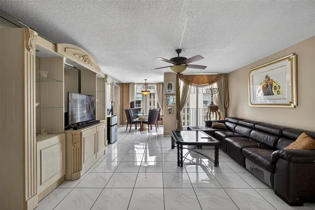 a dining room with furniture a chandelier and wooden floor