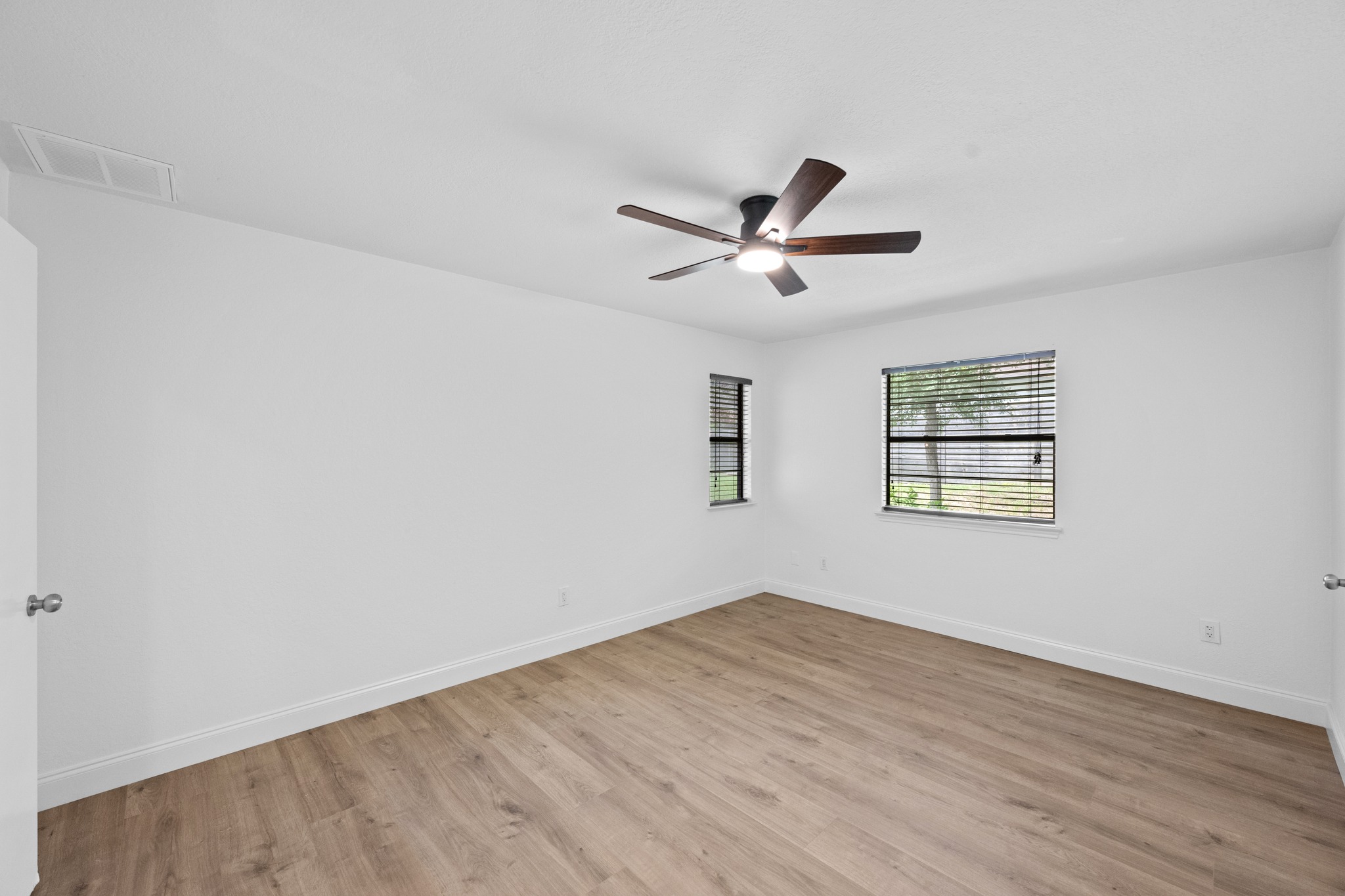 7210 Smokey Hill Road Austin, TX 78736 - Photo 16 of 29 A quiet retreat with fresh flooring and abundant natural light invites comfortable living.