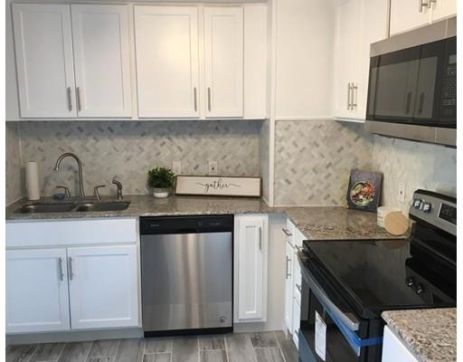 91 Windemere Street Springfield, MA 01104 - Photo 2 of 28 a kitchen with granite countertop white cabinets and a stove
