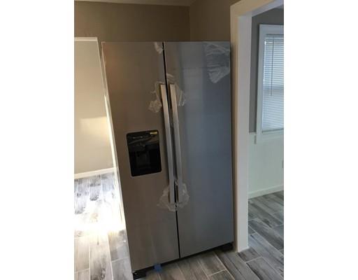 91 Windemere Street Springfield, MA 01104 - Photo 6 of 28 a close view of a refrigerator in kitchen and an empty room
