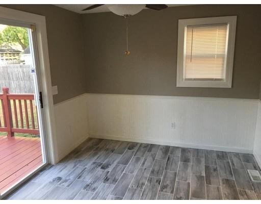 91 Windemere Street Springfield, MA 01104 - Photo 7 of 28 an empty room with wooden floor and windows