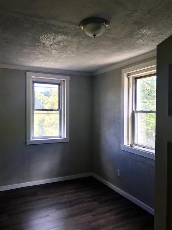 473 Wall Avenue, Unit B Wall, PA 15148 - Photo 4 of 6 a view of an empty room with wooden floor and a window