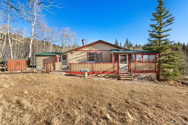 a view of a house with a yard and wooden fence