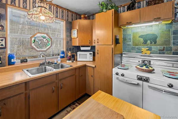 a kitchen with cabinets and window
