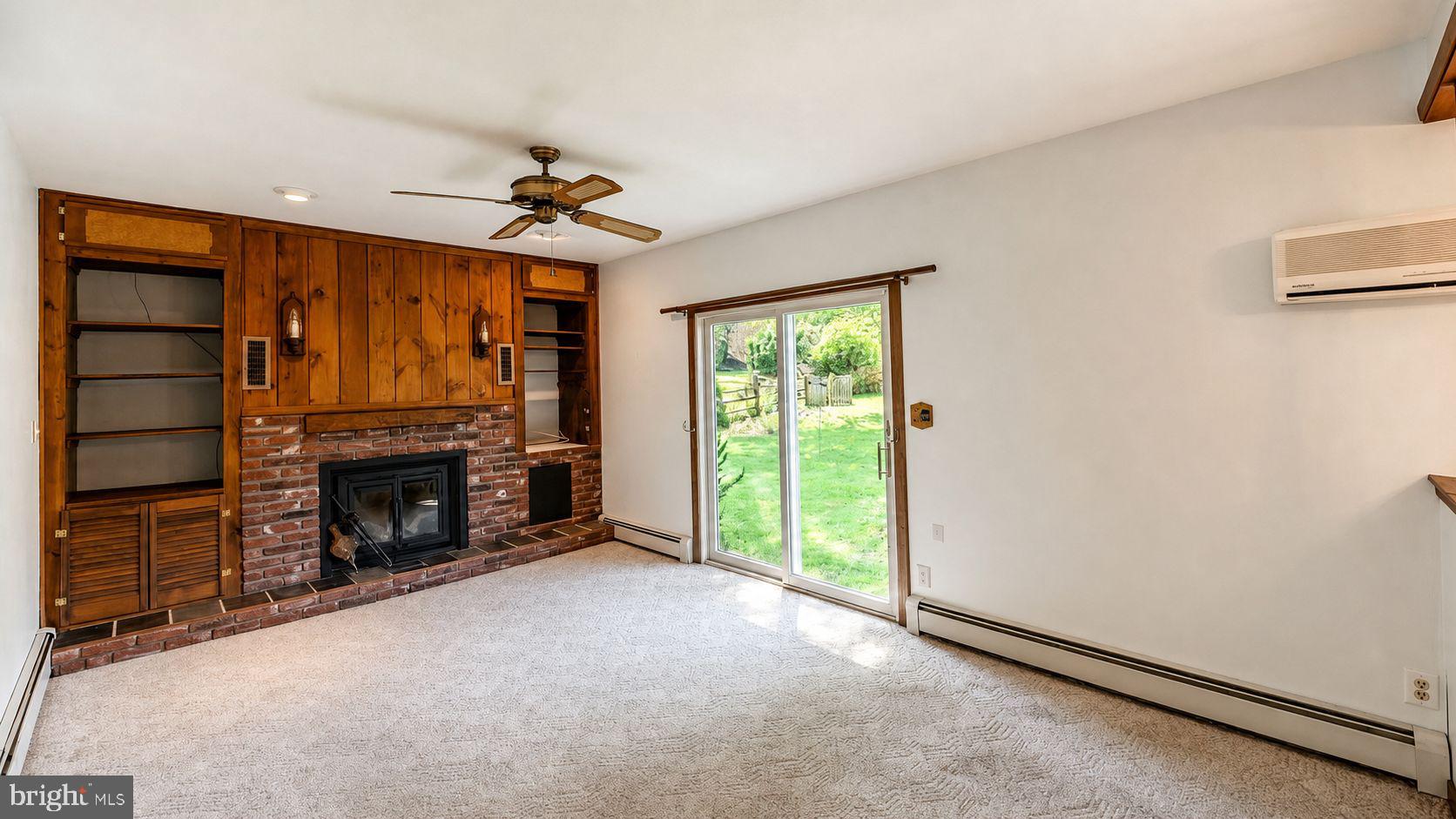 223 Trythall Road Elverson, PA 19520 - Photo 29 of 78 an empty room with furniture fireplace and a window