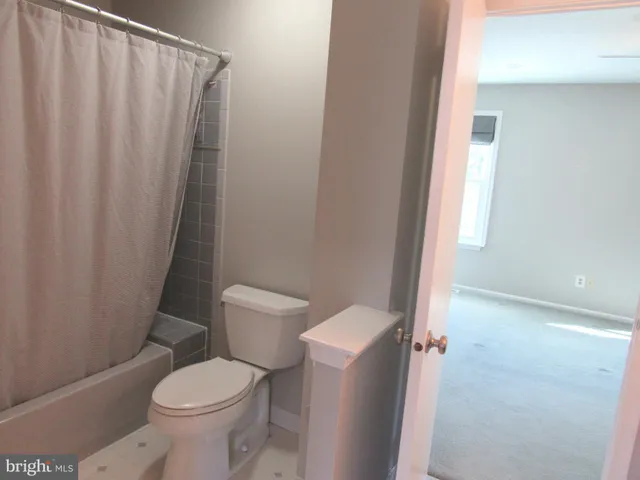 a bathroom with a shower sink and mirror