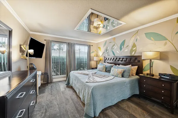 a bedroom with a bed and a tv on the dresser