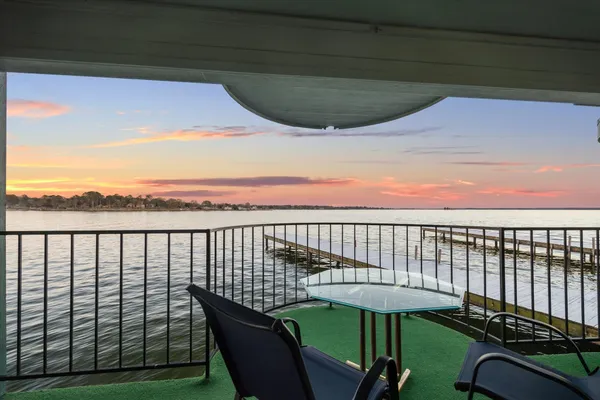 a view of a balcony with chair and table