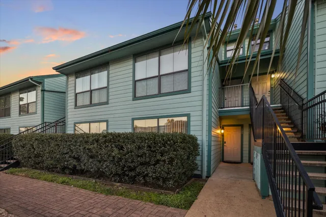 a view of a lake with a big yard and large trees
