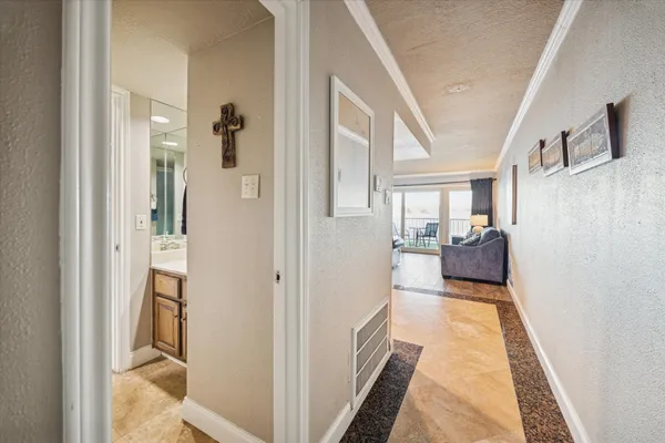 a view of a hallway with wooden floor and furniture