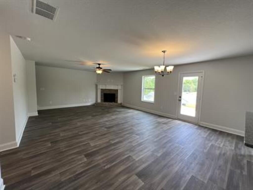 1389 River Mist Circle Jefferson, GA 30549 - Photo 3 of 18 an empty room with wooden floor chandelier and fan