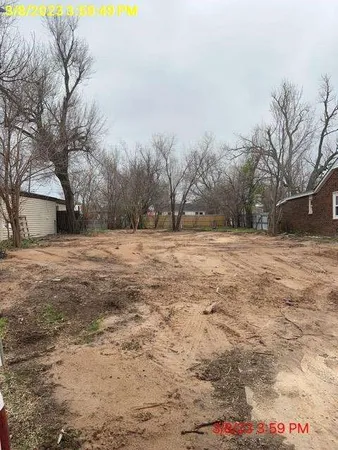 a backyard of a house with large trees