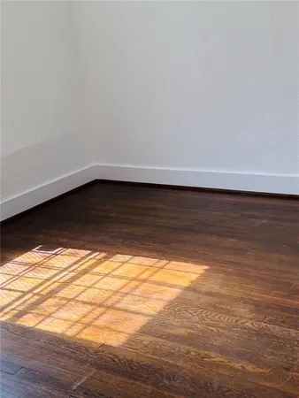a view of room with wooden floor