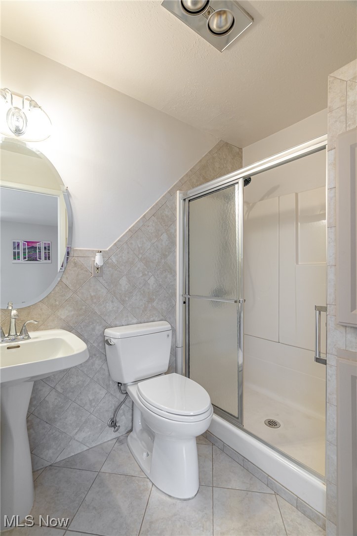 2089 Wooster Road, Unit C42 Rocky River, OH 44116 - Photo 17 of 43 Tiled floors and walls in the primary bathroom and a nice walk in shower