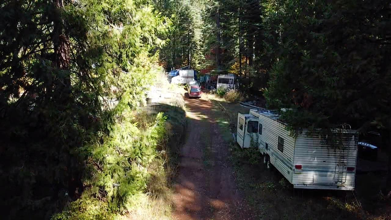 18035 Mobley Springs Road Nevada City, CA 95959 - Photo 12 of 50 a backyard of a house with table and chairs large trees