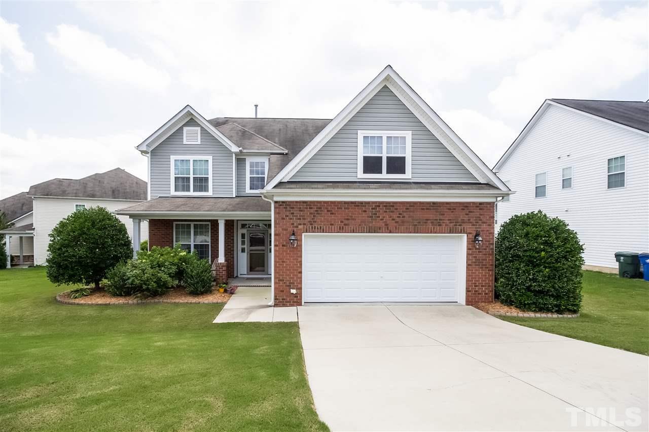 5160 Holly Ridge Farm Road Raleigh, NC 27616 - Photo 1 of 25 a front view of a house with a yard and garage