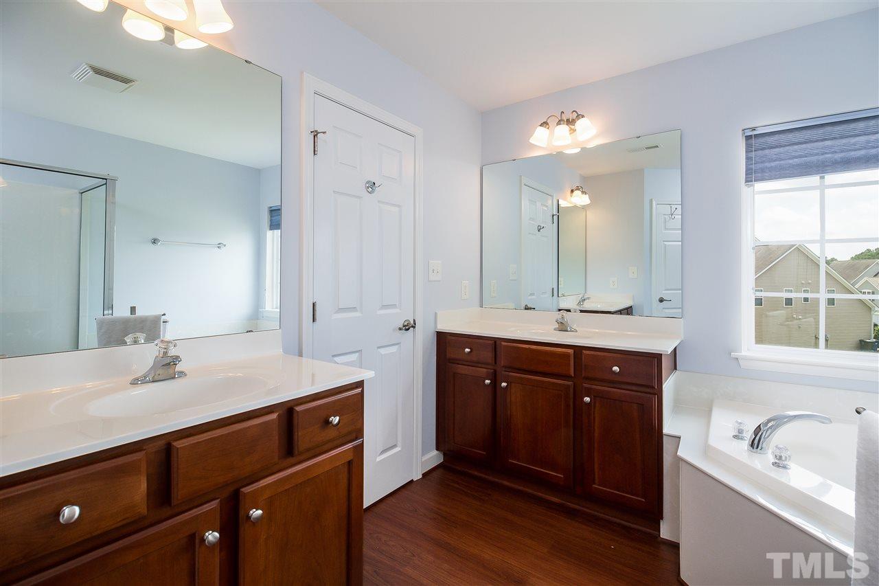 5160 Holly Ridge Farm Road Raleigh, NC 27616 - Photo 13 of 25 a spacious bathroom with a sink double vanity granite tub and a mirror