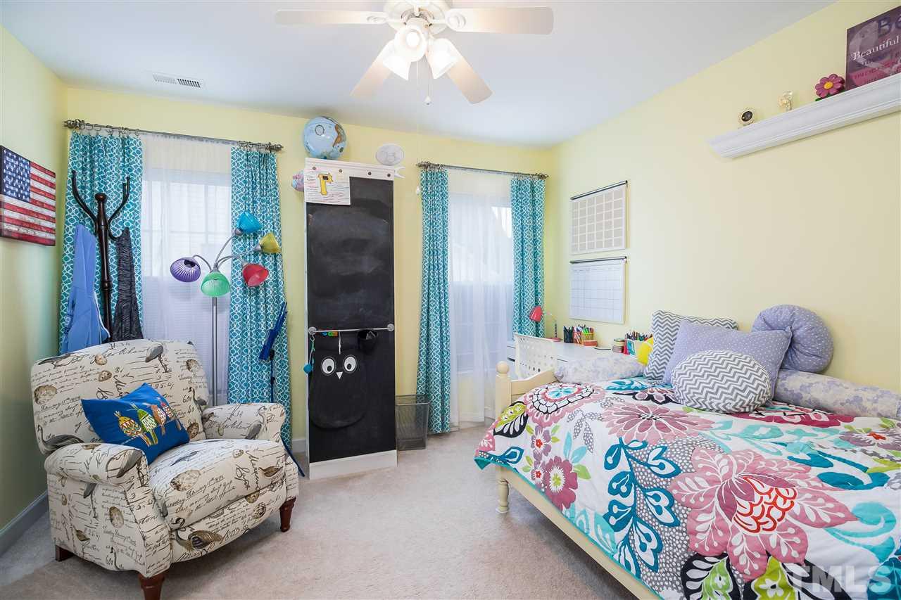 5160 Holly Ridge Farm Road Raleigh, NC 27616 - Photo 16 of 25 a bedroom with a bed dresser and a window