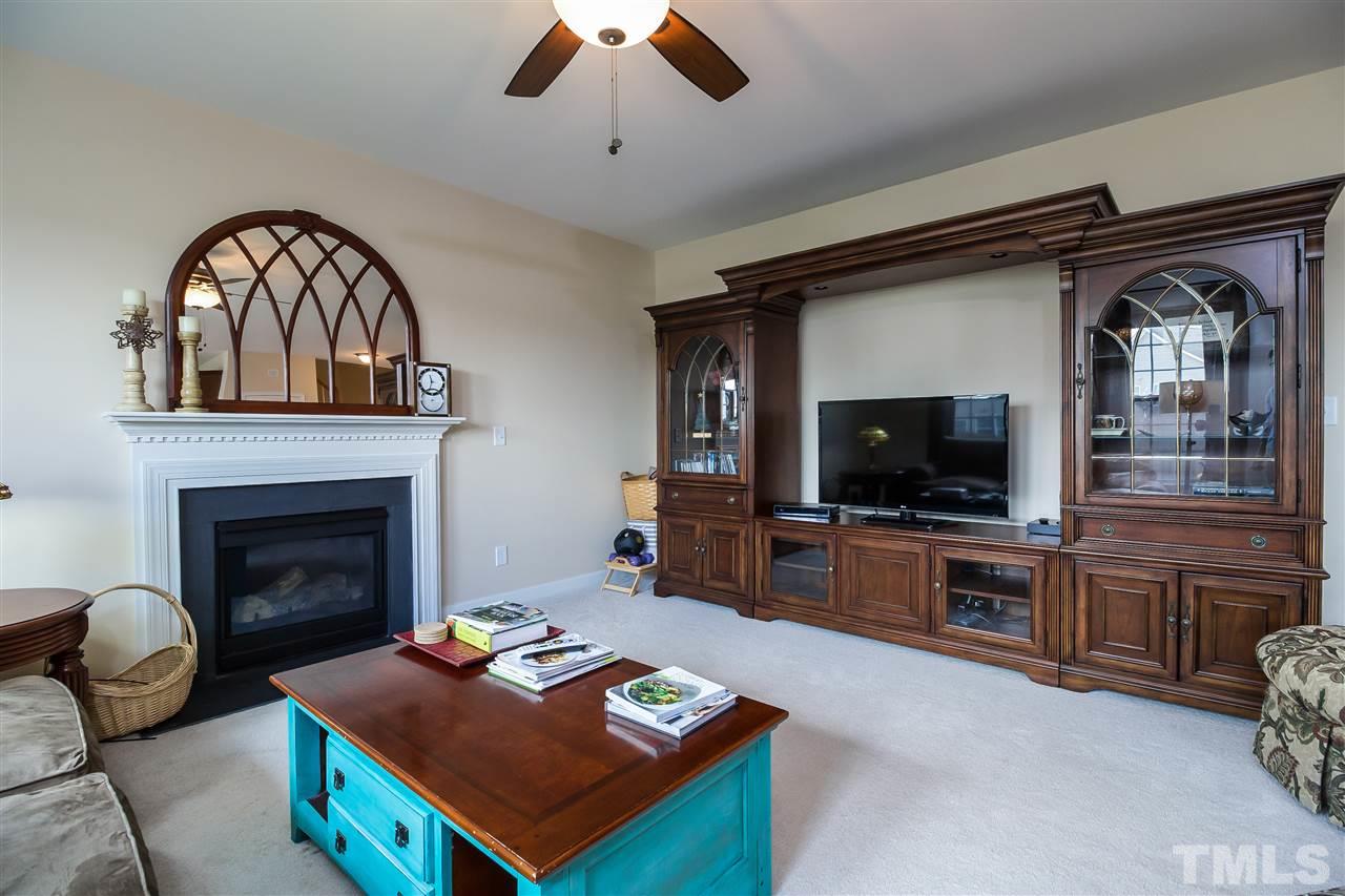 5160 Holly Ridge Farm Road Raleigh, NC 27616 - Photo 3 of 25 a living room with furniture a flat screen tv and a fireplace