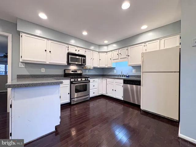a bathroom with a sink a light fixture and a mirror