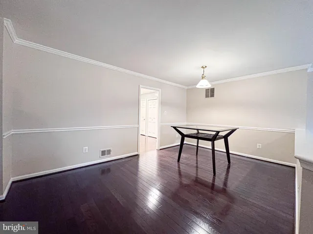 a utility room with stainless steel appliances granite countertop a sink and cabinets