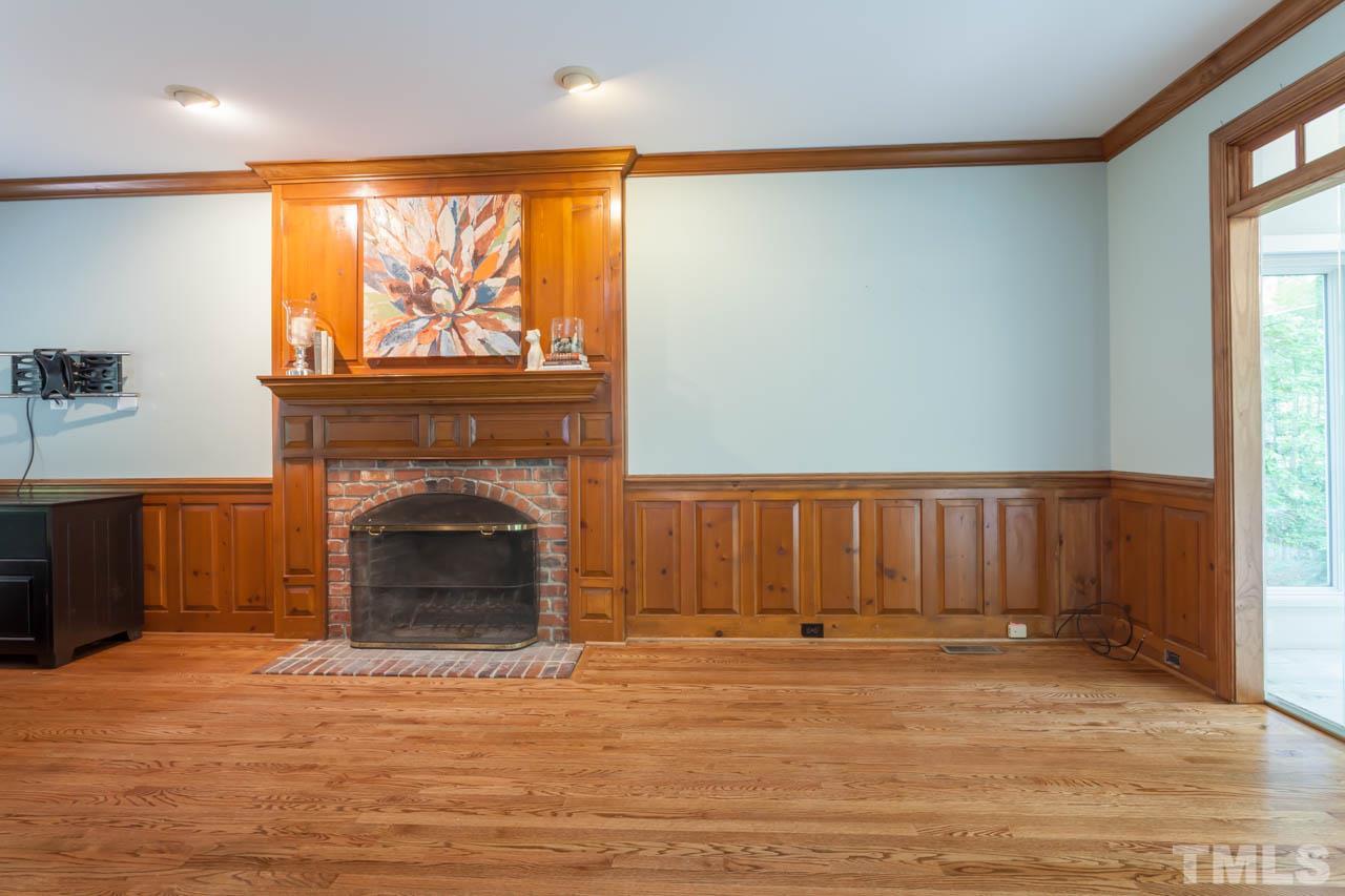 8016 Selfridge Court Raleigh, NC 27615 - Photo 12 of 25 a view of a livingroom with a fireplace and a window