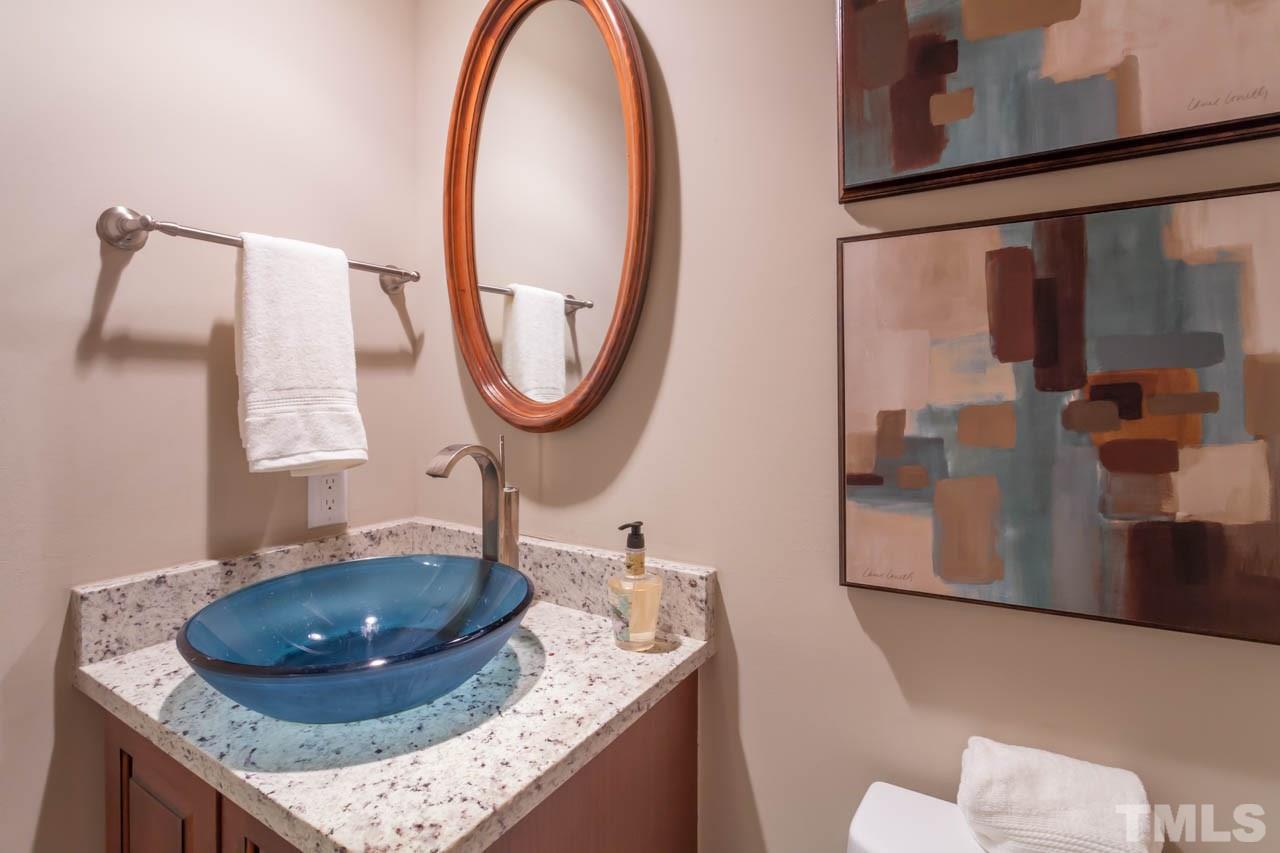 8016 Selfridge Court Raleigh, NC 27615 - Photo 14 of 25 a bathroom with a granite countertop sink and a mirror