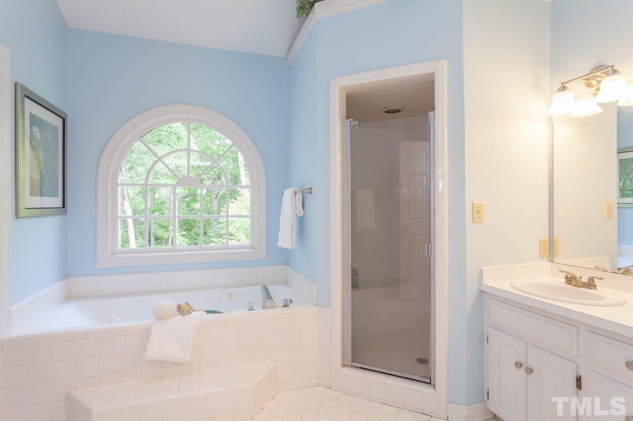 8016 Selfridge Court Raleigh, NC 27615 - Photo 16 of 25 a bathroom with a bathtub and a sink
